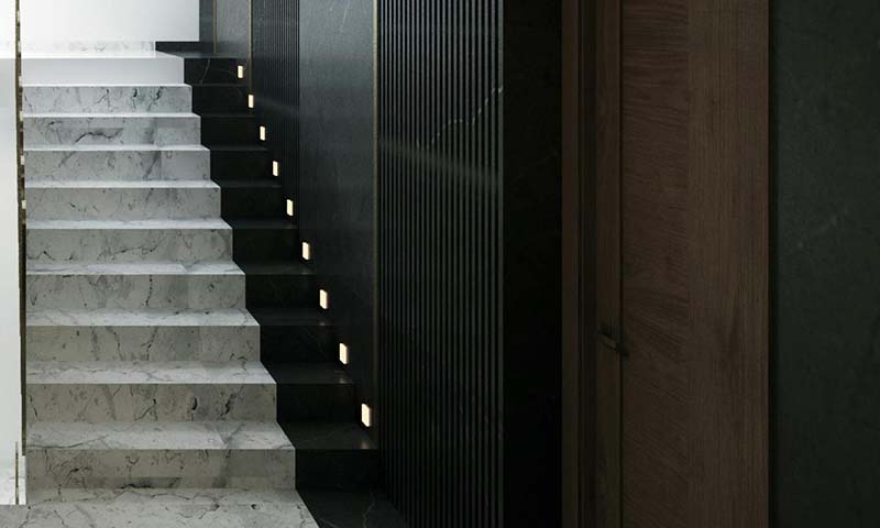 lights at the base of each stair made of marble
