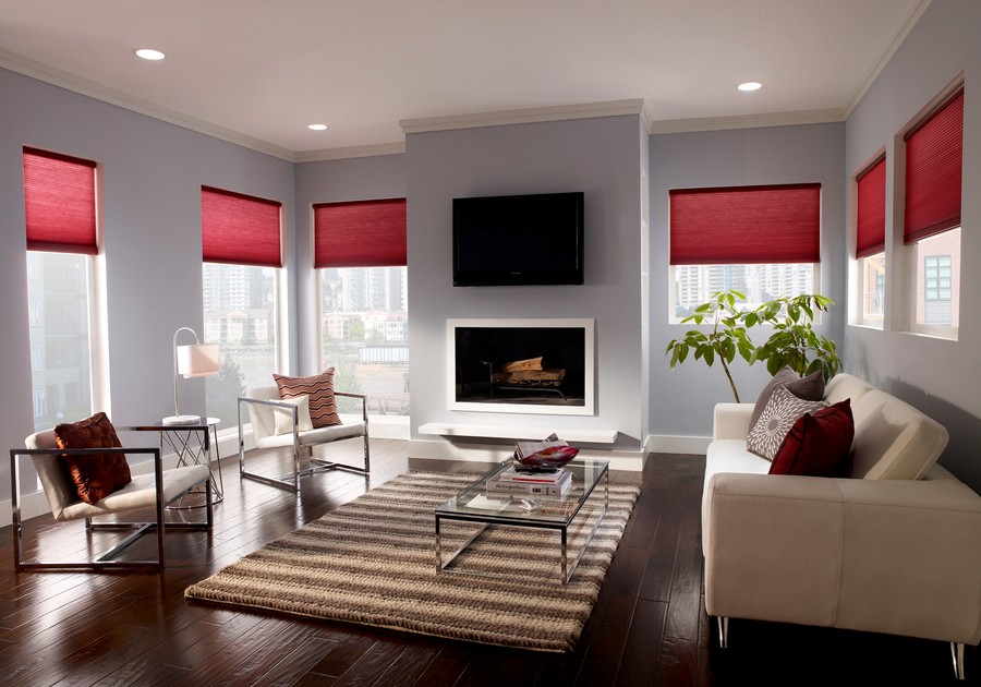 a living room with a glass table and red shades
