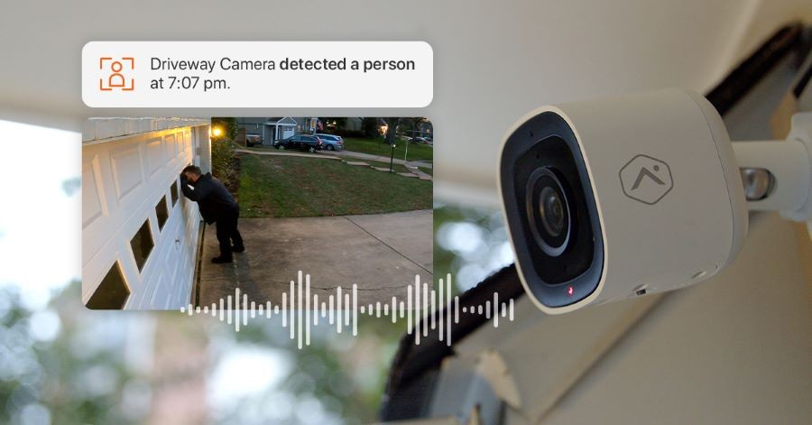 An Alarm.com security camera sending an alert and video clip of a man peering into a home’s garage.