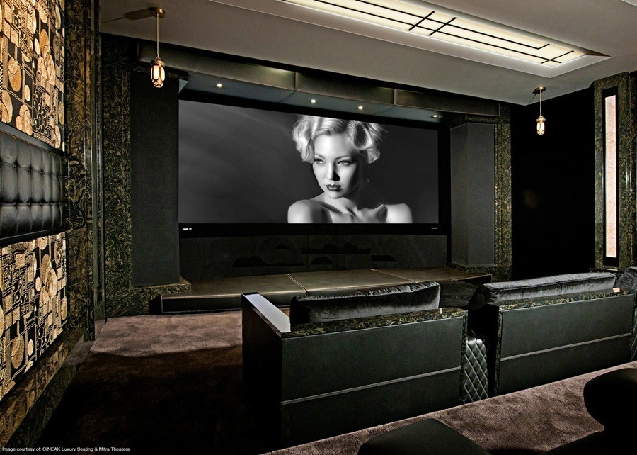  A 1920s style home theater with a black-and-white still of an actress on the screen.