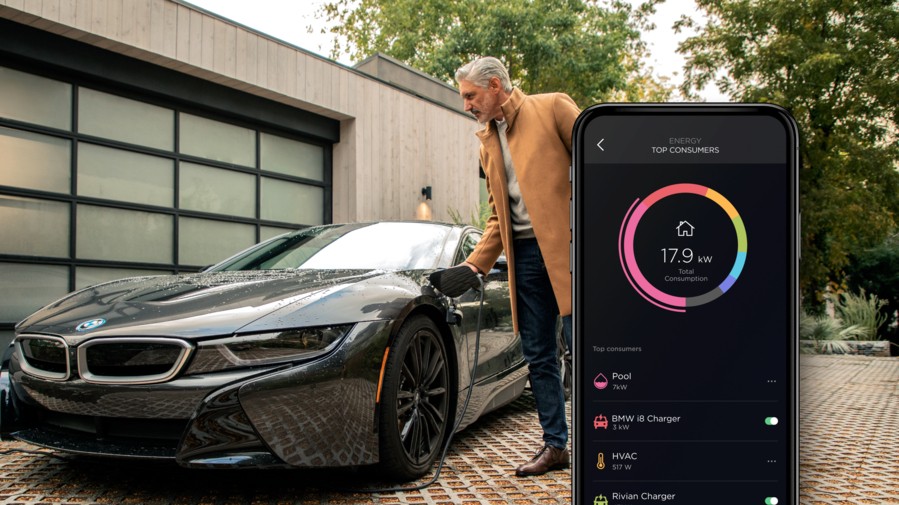 A man in front of a home charging his EV. Overlaid is the Savant Power app. 