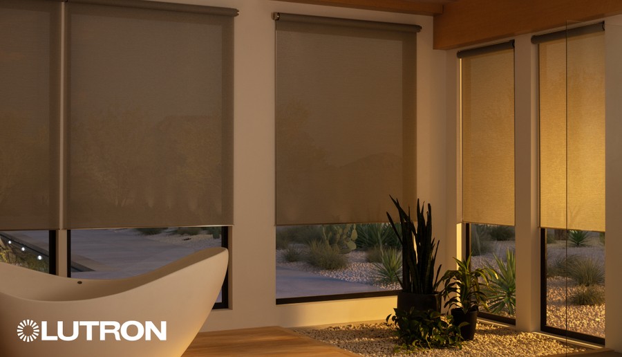 A modern bathroom with a bathtub and Lutron motorized shades lowered.